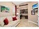 Cozy home office features custom built-ins, a comfortable sofa, and neutral decor at 12935 W Lone Tree Trl, Peoria, AZ 85383