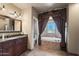 Bathroom with soaking tub, double vanity, and decorative curtains at 146 E Claremont St, Phoenix, AZ 85012