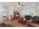 Spacious living room with leather furniture and a ceiling fan at 15893 W Arrowhead Dr, Surprise, AZ 85374