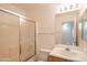 Clean bathroom featuring a shower-tub combo and a vanity with a framed mirror and cabinet storage at 15909 W Elm St, Surprise, AZ 85374