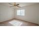 Inviting bedroom with carpet, ceiling fan, and window, offering a comfortable and well-lit space at 15909 W Elm St, Surprise, AZ 85374