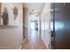 Bright and spacious entryway with wood-look tile flooring and modern wall paneling at 1940 W Kinfield Trl, Phoenix, AZ 85085