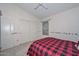 Bedroom with red and black plaid bedding and double doors at 20961 N 96Th Dr, Peoria, AZ 85382