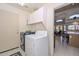 Laundry room with washer, dryer, and built-in shelving at 20961 N 96Th Dr, Peoria, AZ 85382