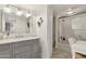 Charming bathroom with gray vanity, hexagon tile shower and white fixtures at 2108 E Pasadena Ave, Phoenix, AZ 85016