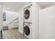 Stackable washer and dryer in a bright laundry room with stairs at 2108 E Pasadena Ave, Phoenix, AZ 85016