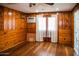 Bright bedroom with wood paneled walls, hardwood floors and french doors at 2157 W Mulberry Dr, Phoenix, AZ 85015