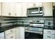 Modern kitchen with stainless steel appliances and granite counters at 2157 W Mulberry Dr, Phoenix, AZ 85015
