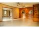 Spacious living room featuring wood paneled walls and a view into another room at 2157 W Mulberry Dr, Phoenix, AZ 85015