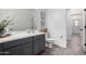 Modern bathroom with gray vanity, toilet, and tile flooring at 23363 S 228Th Pl, Queen Creek, AZ 85142