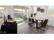 Bright dining area with wooden table and sliding glass doors to backyard at 23363 S 228Th Pl, Queen Creek, AZ 85142