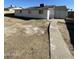 Large backyard with a concrete pathway leading to the back of the house at 2802 N 50Th Ln, Phoenix, AZ 85035