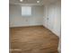 Bright, spacious basement room with wood-look floors and ample natural light at 2802 N 50Th Ln, Phoenix, AZ 85035
