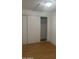 Bright bedroom with sliding door closet and light wood flooring at 2802 N 50Th Ln, Phoenix, AZ 85035