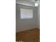Spacious bedroom with wood-look floors and a large window at 2802 N 50Th Ln, Phoenix, AZ 85035