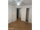 Bedroom with wood-look floors, ceiling fan and access to bathroom and closet at 2802 N 50Th Ln, Phoenix, AZ 85035