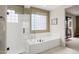 Spa-like bathroom with soaking tub, walk-in shower, and tile floors at 28429 N 101St Pl, Scottsdale, AZ 85262