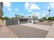 Single story home with gray garage door, modern fence, and gravel driveway at 2928 E Cortez St, Phoenix, AZ 85028