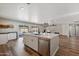 Open concept kitchen with white island, stainless steel appliances, and hardwood floors at 2928 E Cortez St, Phoenix, AZ 85028
