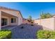 Desert landscape with gravel, shrubs, and a covered patio at 3056 E Palm Beach Dr, Chandler, AZ 85249