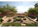 Landscaped entrance to Solera community featuring a stone wall and iron gate at 3056 E Palm Beach Dr, Chandler, AZ 85249