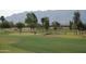 Golf course with players and mountain backdrop at 3056 E Palm Beach Dr, Chandler, AZ 85249