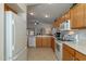 Well-lit kitchen featuring oak cabinets and modern appliances at 3056 E Palm Beach Dr, Chandler, AZ 85249