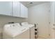 Laundry room with washer, dryer, and overhead cabinets at 3056 E Palm Beach Dr, Chandler, AZ 85249
