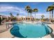 Resort-style pool with palm trees and a clubhouse in background at 3056 E Palm Beach Dr, Chandler, AZ 85249