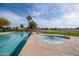 Community pool and hot tub with lounge chairs and golf course view at 3056 E Palm Beach Dr, Chandler, AZ 85249