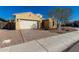 Tan two-car garage home with desert landscaping at 3082 E Jade Ct, Chandler, AZ 85286
