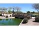 Peaceful lake with a stone bridge and lush landscaping at 3082 E Jade Ct, Chandler, AZ 85286