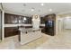 Spacious kitchen with dark wood cabinets, granite countertops, and stainless steel appliances at 333 N Calle Largo --, Mesa, AZ 85207