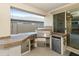 Outdoor kitchen with grill, mini-fridge, and stone countertops at 333 N Calle Largo --, Mesa, AZ 85207