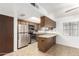 Compact kitchen with stainless steel appliances, wooden cabinets and tile backsplash at 402 E South Ave, Buckeye, AZ 85326