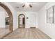 Bright living room with carpet flooring, brick archways, and neutral paint at 402 E South Ave, Buckeye, AZ 85326