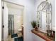 Guest bathroom with a decorative mirror and tiled shelf at 41999 W Solitare Dr, Maricopa, AZ 85138