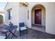 Front entrance featuring an arched doorway and welcoming mat at 41999 W Solitare Dr, Maricopa, AZ 85138