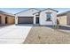 Charming single-story home featuring a low-maintenance desert landscape and a two car garage at 47771 W Mellen Ln, Maricopa, AZ 85139