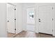 Bright entryway with durable wood flooring and white doors provides a clean and welcoming entrance to the home at 47771 W Mellen Ln, Maricopa, AZ 85139