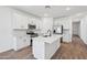 Modern kitchen featuring a central island, sleek white cabinetry, and stainless steel appliances at 47771 W Mellen Ln, Maricopa, AZ 85139