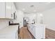 Modern kitchen with a large island, white cabinets, and stainless steel appliances at 47771 W Mellen Ln, Maricopa, AZ 85139