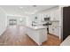 Bright kitchen featuring an island, white cabinets, and stainless steel appliances at 47771 W Mellen Ln, Maricopa, AZ 85139