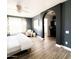 Main bedroom with a king-size bed, ceiling fan, and an arched entryway to the en-suite bathroom at 482 S Terrace Rd, Chandler, AZ 85226