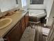 Main bathroom with updated vanity, large tub, and wood flooring at 51989 W Esch Trl, Maricopa, AZ 85139
