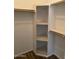 Spacious corner closet with shelving and hanging rods at 51989 W Esch Trl, Maricopa, AZ 85139