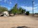 View of the home's exterior, showing a rustic style and a spacious yard at 51989 W Esch Trl, Maricopa, AZ 85139