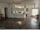 Bright living room with open floor plan and kitchen access at 51989 W Esch Trl, Maricopa, AZ 85139