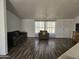 Living room with wood-look floors and neutral decor at 51989 W Esch Trl, Maricopa, AZ 85139