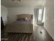 Large main bedroom with tufted headboard and ample natural light at 51989 W Esch Trl, Maricopa, AZ 85139